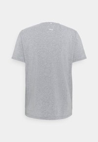 Camiseta gris de manga corta hecha de una mezcla de algodón, con cuello redondo y un pequeño detalle de logo en la parte superior de la espalda. Textura suave.