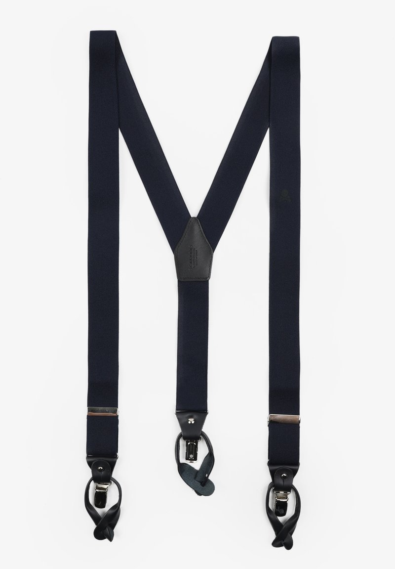Tirantes elásticos en azul marino con un parche central de cuero negro y herrajes plateados. Diseñados en forma de 'M' con sujetadores de clip.