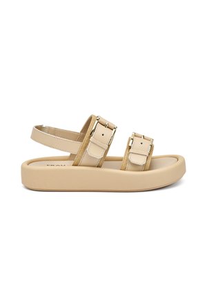 Sandalo beige con due cinturini regolabili dotati di fibbie metalliche, suola piatta e soletta testurizzata per il comfort.