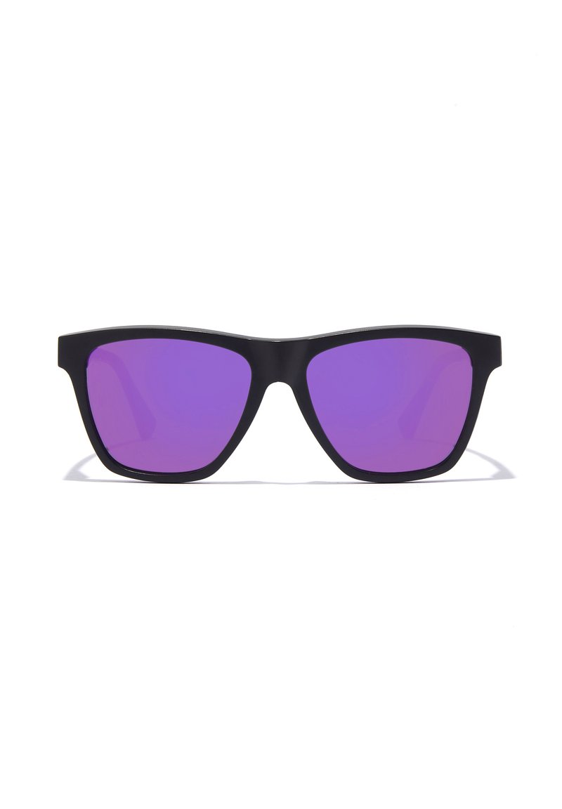 Black sunglasses featuring a geometric design and purple-tinted lenses. The frames are solid and angular with a matte finish.