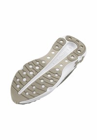 Shoe outsole featuring a textured, beige rubber surface with circular cutouts and a white accent line. Designed for traction and flexibility.