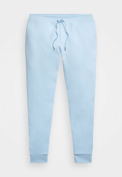 Calças de sweat azul claro com cintura elástica, cordão ajustável e bainhas. Feitas de um tecido macio com um pequeno detalhe de logotipo.