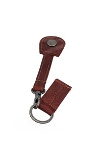 Brown leather keychain with metal ring and snap button, stitched details, and embossed text "Graff Leather studio" on one leather piece.