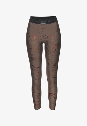 Braune Leggings mit einem wirbelnden Muster in metallischen Kupfertönen, versehen mit einem schwarzen Bund mit erhabenem Text. Glatte Stofftextur.
