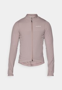 Giacca da ciclismo a maniche lunghe rosa chiaro in tessuto elasticizzato, con zip frontale e orlo leggermente curvato. Branding minimale sul petto.
