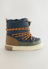 Blå höga stövlar med orange snören, bruna och gröna accenter, en vadderad krage och en vit gummisula, med en texturerad yta.