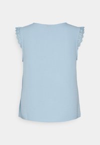 Light blue sleeveless top with scalloped lace accents on shoulders, round neckline, and a straight hem; made from soft, textured fabric.