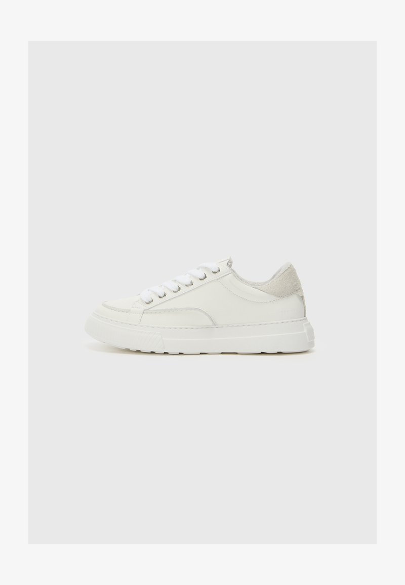 White leather sneakers with a textured light gray heel accent, lace-up design, rounded toe, and a chunky rubber sole.