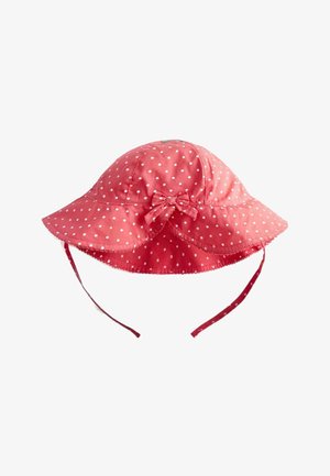 Pălărie de soare roz cu boruri largi cu buline albe, o fundiță mică în față și barete reglabile pentru bărbie.