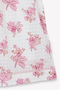 White fabric with a grid pattern, featuring pink and gold floral embroidery. Hem has a delicate stitched finish. Lightweight and textured appearance.