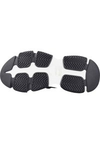 Semelle de chaussure en caoutchouc noir avec un motif texturé pour une meilleure adhérence, présentant une section centrale blanche et un design de bord lisse.