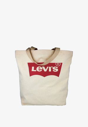 Bolsa de lona beige con asas marrones y un gran logotipo rojo de Levi's impreso en el centro frontal.