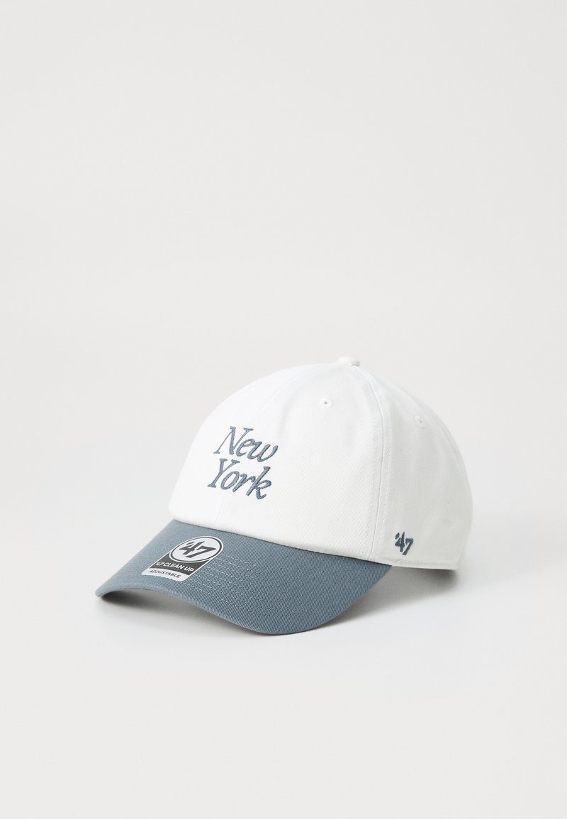 White baseball cap with gray brim, embroidered "New York" in blue script, and a branded patch on the front. Smooth fabric texture.