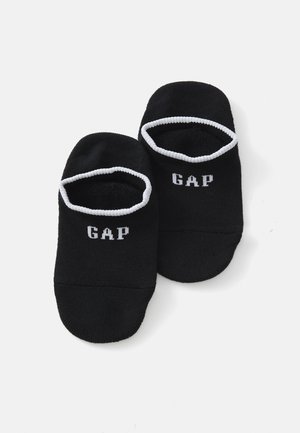 Crne čarape bez peta s bijelim kontrastnim rubom i bijelim ispisom "GAP" logo na gornjoj strani. Mekani materijal, rastezljivi materijal.