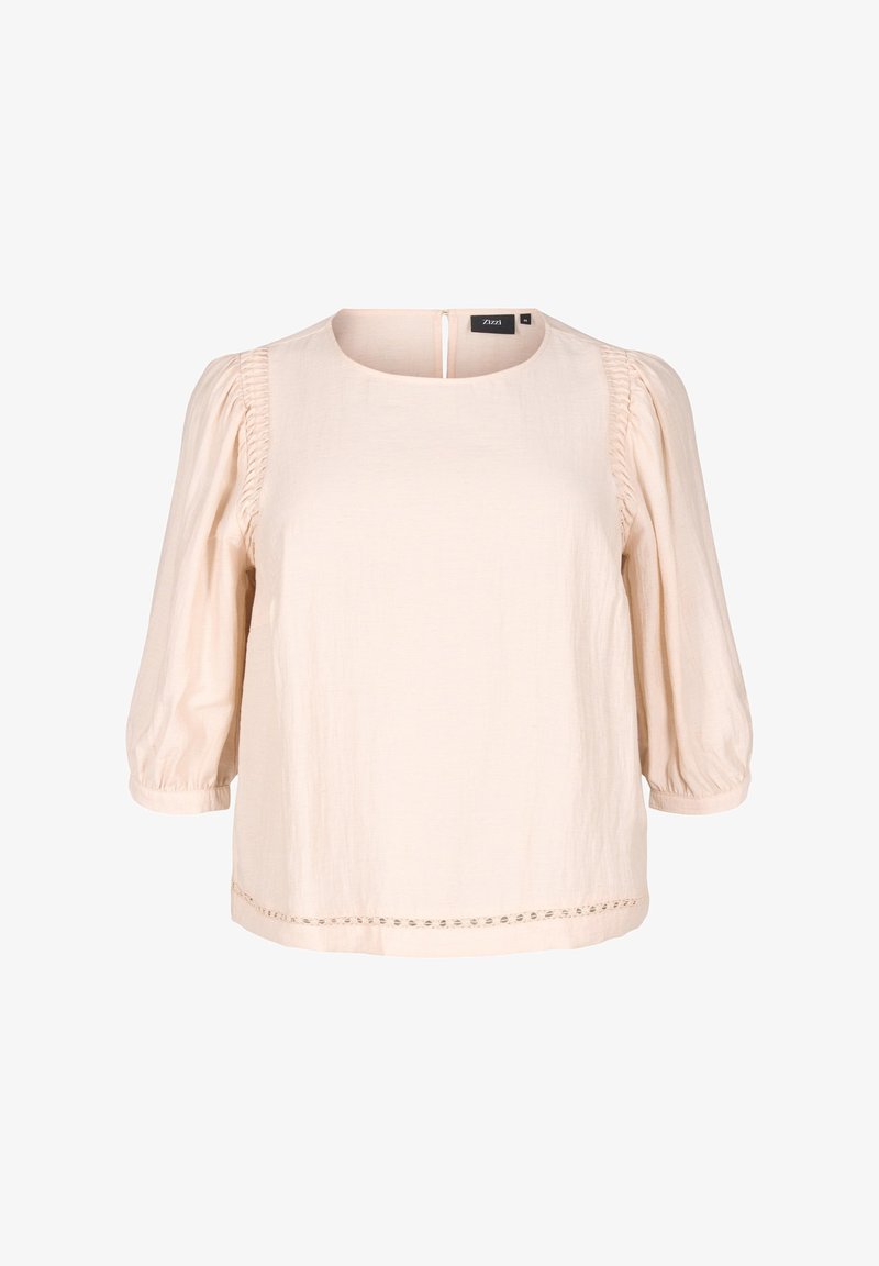 Blusa beige chiaro con collo rotondo e maniche a sbuffo tre quarti. Presenta lati plissettati e un bordo decorativo all'orlo.