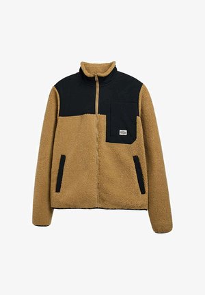 Beige og sort sherpa fleecejakke med fuld frontlynlås, sort brystlomme og to sidelommer med sort kant.