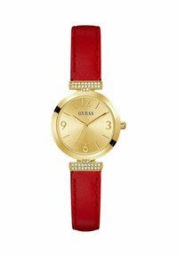 Reloj dorado con una esfera texturizada, correa de cuero rojo y herrajes con cristales en los soportes. Presenta marcadores de hora en negrita.