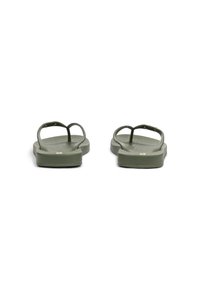 Green flip-flops with a textured sole and flat design, featuring thin straps and circular hardware accents.