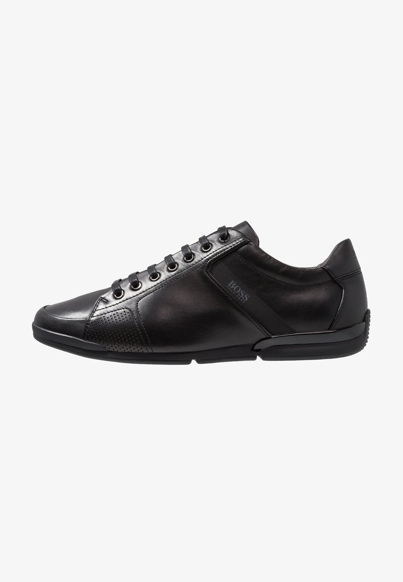 Baskets en cuir noir profil bas avec laçage à l’avant, zone des orteils perforée et logo « BOSS » sur le côté.