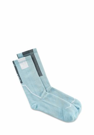 Light blue crew socks with black, white, and gray geometric patterns, laid flat on a white background.