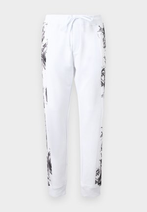 White jogger pants with black and gray marble-patterned side panels and a front drawstring waist.