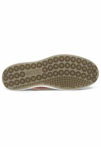 Shoe sole features a rubber base with circular grips, a beige color, and a textured design with small raised dots for traction.