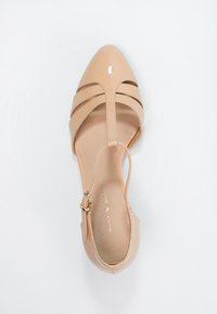 Nude lakované lodičky s špičatou špičkou a ankletovým páskem, které mají na svršku tři vodorovné výřezy a hladké vnitřní podšití.