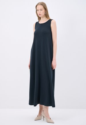 Laivansinis ilmanhiha dress, jossa on pyöreä pääntie ja hienovaraiset saumat. Mallilla on päällään beiget korkokengät, ja hän seisoo valkoisella taustalla.