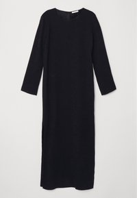 Robe longue noire avec manches longues, encolure ronde et fente latérale, présentée sur un fond plat et clair.