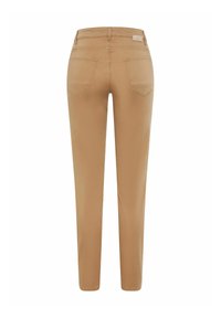 Tan slim-fit pants with a smooth texture, featuring two back pockets and a small branding tag on the waistband.