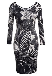 Svart och vit blommig långärmad klänning med en figurnära design, featuring en rundad halsringning, botaniska mönster och kontrasterande texturer.
