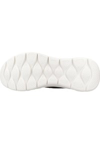Sole of a shoe featuring a textured white rubber bottom with a wavy pattern and spaced oval indentations for traction.
