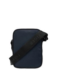 Námořnicky modrá obdélníková kabelka s hladkým látkovým povrchem, černým nastavitelným popruhem s vytlačeným logem a kontrastním lemováním.