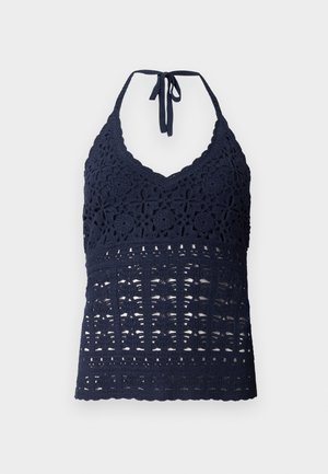 Tumesini heegeldatud halter-top, millel on V-kaelus, keerukad lille- ja geomeetrilised mustrid ning kaela peal köitmise võimalus. Tekstuuriga kangas.