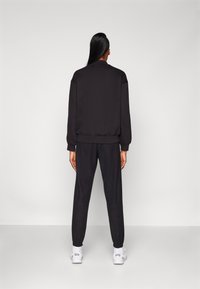 Champion ELASTIC CUFF PANTS QUICK DRY - Treniņtērpa apakšdaļas - black