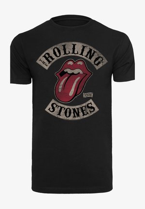 Schwarzes Baumwoll-T-Shirt mit einem abgenutzten roten Zungenlogo, darüber und darunter der Text "The Rolling Stones" in einer Vintage-Schriftart.