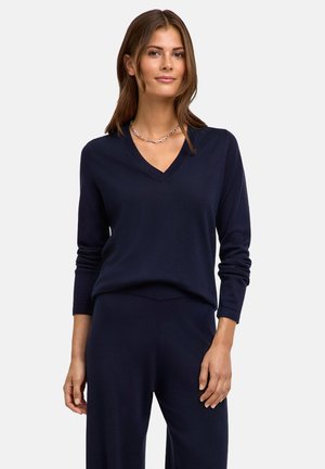 Maglione blu navy a V con maniche lunghe, realizzato in tessuto morbido. Presenta una vestibilità comoda e dettagli a costine ai polsini.