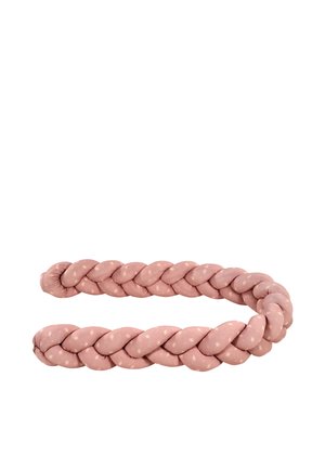 Soft, pink, braided fabric cushion with small heart patterns, shaped in a loose oval on a white background.
