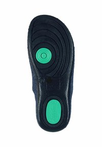Black rubber shoe sole with textured patterns, green circular accents, and a thick dark outer layer. Smooth, slightly cushioned design.