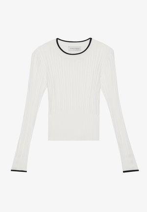 Un haut à manches longues blanc à côtes avec un design ajusté, présentant un accent noir sur l'encolure ronde et les bords des manches. Texture douce sur l'ensemble.