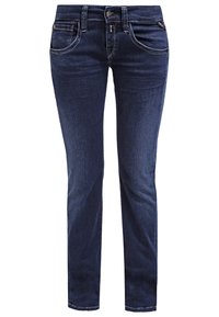 Jeans de denim azul oscuro con piernas rectas, cinco bolsillos y detalles de costura sutiles. Fabricados con un tejido suave y duradero con una textura lisa.