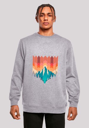 Grey sweatshirt featuring a graphic print of mountains and trees in orange, pink, and teal. Crew neck and ribbed cuffs and hem.