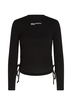 Haut noir à manches longues avec un design ajusté, texture côtelée et détails de cordon de serrage sur les côtés. Logo "KARL LAGERFELD JEANS" en blanc sur le devant.