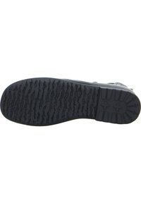 Suola di scarpa in gomma nera con un motivo di battistrada testurizzato per una buona presa, con linee in rilievo e un tallone arrotondato per la stabilità.