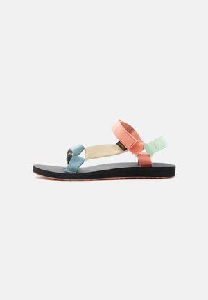 Flat sandal with black sole and adjustable straps in pastel blue, beige, coral, and mint green against a white background.