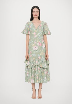 Floral maxi dress in soft green, featuring a V-neck, ruffled short sleeves, and tiered ruffle hem. Decorated with pink and blue flowers.