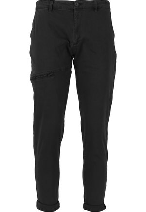 Pantalons noirs à design ajusté, en tissu coton, avec une poche latérale zippée et des poignets roulés pour un look décontracté.
