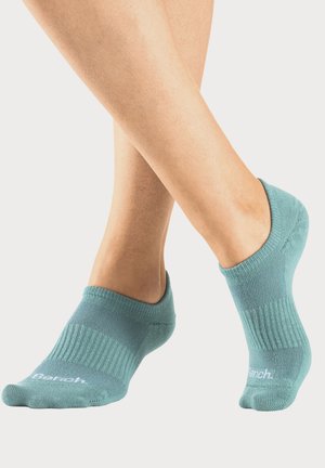 Türkise Knöchelsocken aus weichem Material, mit geripptem Design, runder Zehenpartie und Logo an der Seite für zusätzliche Details.