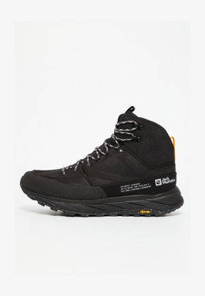 Stivale da trekking nero con tomaia in mesh e suede, lacci riflettenti, intersuola ammortizzata e suola Vibram per trazione e durata.