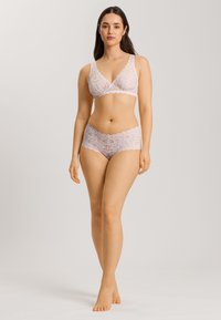 Lace lingerie setti pehmeässä vaaleanpunaisessa, jossa on leveät hihnat omaava bralette ja yhteensopivat shortsit, molemmissa on viistetyt reunat ja kukkakuviot.